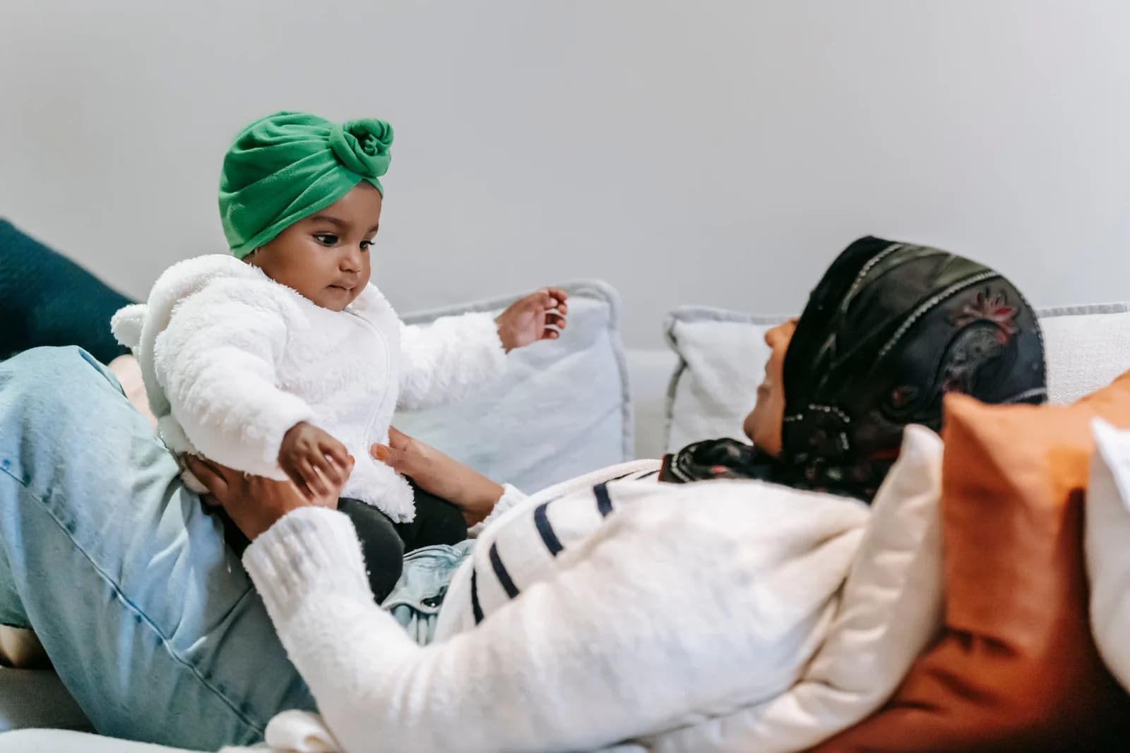 Mother playing with her baby at home